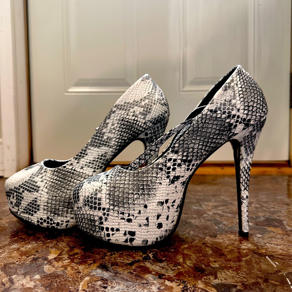 Elevate your footwear game with these Fereshte Snake Skin Heels